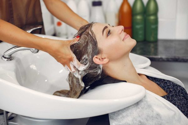 woman washing head hairsalon 1 scaled 1